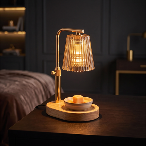 Candle Warmer Lamp glowing warm amber on a dark wood desk